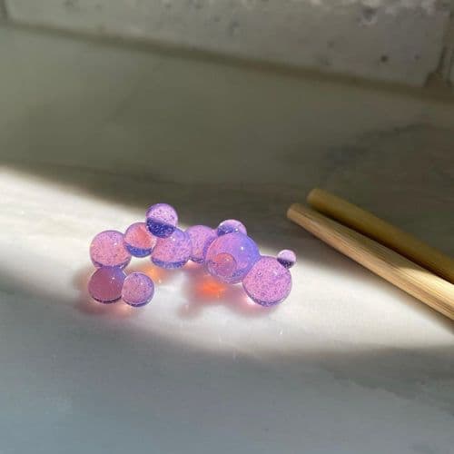 A purple glass chopstick rest